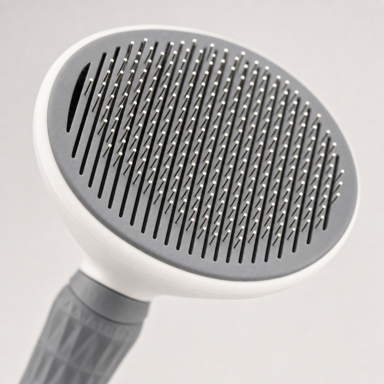 Close-up of the Magic Comb's fine floating needles and self-cleaning slits